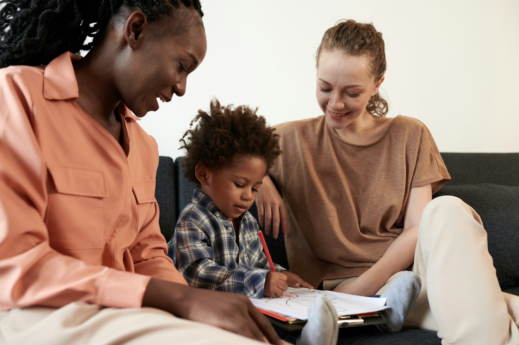 Mothers Looking at Kid Coloring Picture